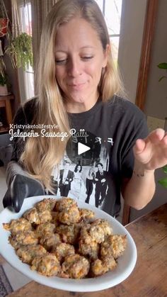 a woman holding a plate full of food