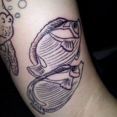 a fish with bubbles and an octopus on it's arm is depicted in this tattoo design