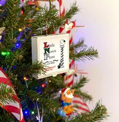 a christmas tree decorated with candy canes and ornaments, including an ornament