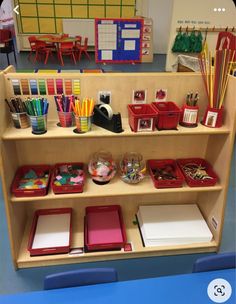 there are many different items on the shelf in this classroom setting, including pens and pencils