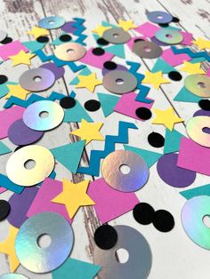 colorful paper cut outs with circles and stars on them