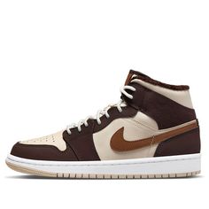 Feel the full power of your jump with the Air Jordan 1 Mid SE Brown Basalt Oatmeal Women. Boasting a timeless design reminiscent of the original silhouette, this Jordan model is a sophisticated take on style and performance. Crafted from beige tumbled leather, it features dark brown Durabuck overlays for durability. The wheat-colored Pecan Swooshes add a modern touch to the classic design. Adding to the winterized look, the inside is thoroughly lined with luxurious dark brown shearling fleece, ensuring you stay warm and comfortable in any conditions. To top it off, smooth white and beige Air soles in the midsole deliver superb cushioning with every step while protecting your feet from impact. With an iconic aesthetic inspired by its namesake’s game-changing abilities on court, this sneaker Cute Jordans, Iconic Aesthetic, Wmns Air Jordan 1, Jordan Model, Air Jordan 1 Mid Se, Womens Air Jordans, White And Beige, Air Jordan 1 Mid, Jordan 1 Mid