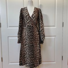 Take A Walk On The Wild Side With This Leopard-Printed Wrap Dress From Ganni. Crafted From Silk-Viscose, The Design Has A Surplice Neckline, Long Sleeves, And A Straight Silhouette. -Leopard-Print -Gathered Sleeves -Buttoned Cuffs -Ties At Waist -Slightly Stretchy Fabric -55% Viscose/45% Silk A Fr 36 Is Equivalent To A Us4 Elegant Leopard Print V-neck Midi Dress, Fitted Leopard Print V-neck Midi Dress, Elegant Knee-length Leopard Print Dress, Elegant V-neck Leopard Print Midi Dress, Leopard Print Midi Dress For Brunch, Fitted Leopard Print Daywear Dress, Fitted Leopard Print Day Dresses, Fitted Leopard Print Dresses For Daywear, Button Down Denim Dress