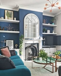 a living room filled with furniture and a fire place in front of a tv mounted on a wall