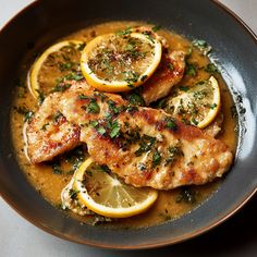 chicken with lemons and herbs served in a bowl