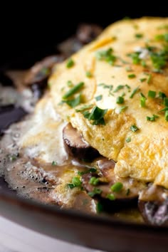 an omelet with mushrooms and parsley in a skillet