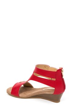 A trio of buckles secure the faux-leather vamp of this side-cutout sandal that sits on a lofty wedge heel. 1 3/4" heel Synthetic upper, lining and sole Imported Red Open Toe Wedge Sandals With Buckle, Red Open Toe Wedge Sandals With Buckle Closure, Red Flat Sandals With Buckle Closure, Red Flat Heel Sandals With Buckle Closure, Wedge Heel Sandals, Heel Sandal, Nordstrom Store, Anniversary Sale, Sandal Women