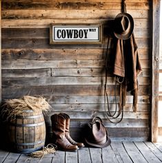 cowboy boots and hats are sitting on the floor in front of a sign that reads, cowboys way