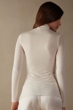 Modal Cashmere Ultralight High-Neck Top | Intimissimi Elegant Winter Tops With Thumbholes, Elegant Stretch White Turtleneck, Elegant White Stretch Turtleneck, Elegant High Stretch Tops With Thumbholes, Elegant Long Sleeve Tops With Soft Stretch, Elegant Long Sleeve Soft Stretch Tops, Elegant High Stretch Mock Neck Top For Spring, Seamless Turtleneck Top For Layering, Elegant High Stretch High Neck Tops