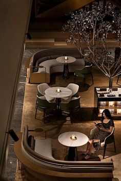 a woman sitting at a table in a restaurant