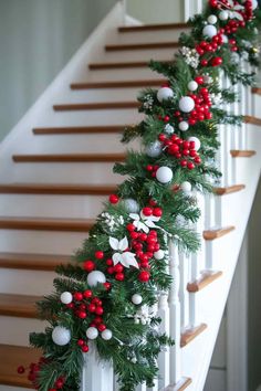 christmas garland on the banister with red and white ornaments