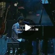 an image of a man playing the piano and singing on stage with other instruments in the background