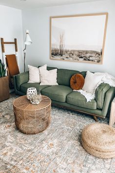 a living room with a green couch and two wicker tables in front of it