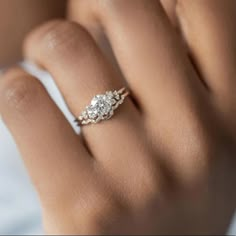 a woman's hand with a diamond ring on it