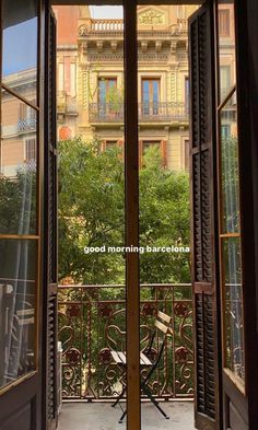 an open door with the words good morning barcelona written on it in front of a building