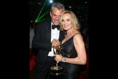 a man and woman posing with an award