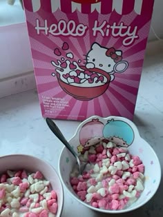 two bowls filled with cereal next to a hello kitty box