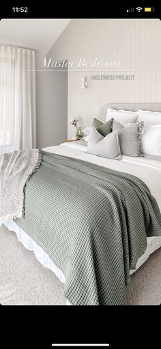 a white bed sitting in a bedroom next to a window