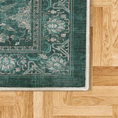 a green rug with an ornate design on it