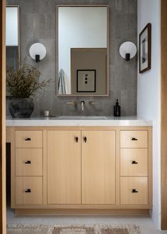 a bathroom vanity with two mirrors above it