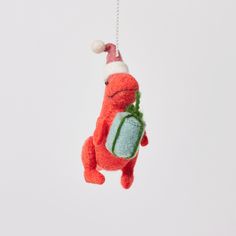 a red stuffed animal hanging from a string