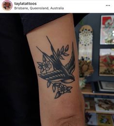 a small bird tattoo on the arm