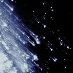 an image of rain falling down on the ground in the dark night sky with white clouds