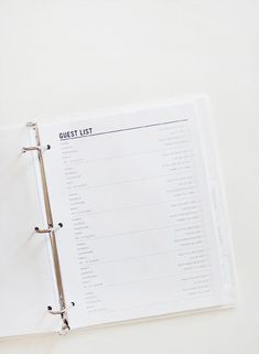 an open planner sitting on top of a white table