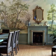 a dining room with a fireplace and painted wall