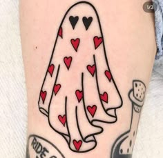 a woman's leg with a tattoo on it that has hearts in the shape of a ghost