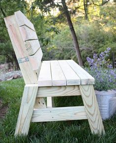 a wooden bench sitting in the grass