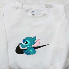 Stitch x Swoosh Embroidered Sweatshirt, Disney Characters Embroidered Hoodie, Best Gift Ideas for Family Welcome to the enchanting world of Tinicloset, where every thread tells a story and your wardrobe becomes a canvas for creativity! Our store is a delightful haven for those seeking custom embroidered apparel that fuses the charm of Disney with the... Cute Custom Embroidered Sweatshirt For Streetwear, Cute Hoodie With Custom Embroidery And Crew Neck, Cute Custom Embroidered Crew Neck Hoodie, Cute Hoodie With Embroidered Graphics For Streetwear, Cute Hooded Sweatshirt With Embroidered Graphics, Cute Hooded Sweatshirt With Custom Embroidery, Cute Hooded Hoodie With Embroidered Logo, White Hooded Top With Machine Embroidery, Cute Hooded Tops With Embroidered Logo