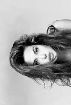 a black and white photo of a woman with long hair