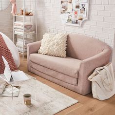 a living room with a couch, chair and coffee cup on the floor in front of it