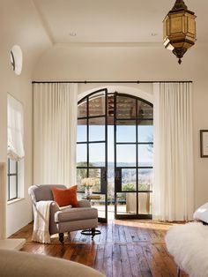 a living room with a couch, chair and sliding glass doors