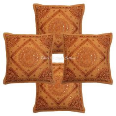 three decorative pillows with beading on the sides and an embroidered design on the back