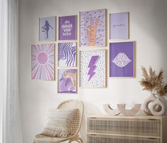 a white chair sitting in front of a wall with pictures on the wall above it