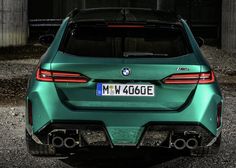 the rear end of a green bmw suv