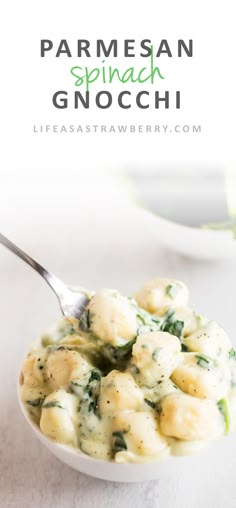 a white bowl filled with spinach gnocchini on top of a table