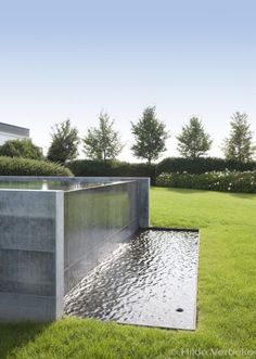 a water feature in the middle of a grassy field