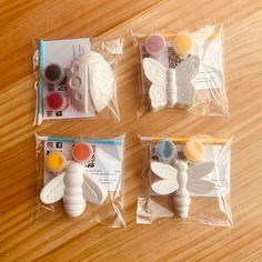 three bags of crafting supplies sitting on top of a wooden table