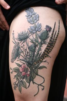 a woman's thigh with flowers on it