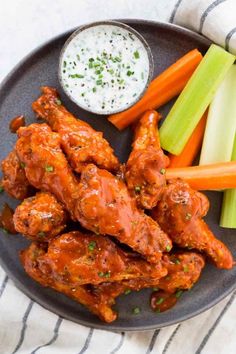 chicken wings with celery, carrots and celery sticks on a plate