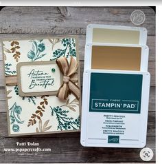 the stampin pad is next to an open card with a bow on it and a tag