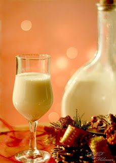 a glass and bottle of milk on a table