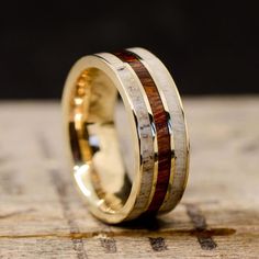 a wedding ring with two wood inlays