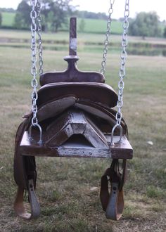 a wooden swing with chains attached to it