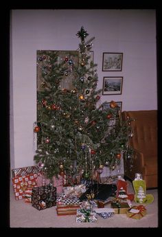 a small christmas tree with presents under it