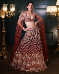 Caramel brown lehenga set features all over sequin, crystal, cutdana and bead embroidery, with coloured accents throughout the lehenga. Paired with a strappy corset blouse with a dramatic shoulder cap detailing and attached drapes.DELIVERY TIMEPlease allow 8-12 weeks for your outfit to arrive.FABRIC DETAILSNetProfessional cleaning only. Brown Lehenga, Corset Blouse, Global Dress, Indian Bridal Outfits, Maroon Red, Caramel Brown, Women Wedding Guest Dresses, Bead Embroidery, Bridal Outfits