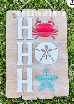 a wooden sign that says the personalized beach with crab, starfish and shell